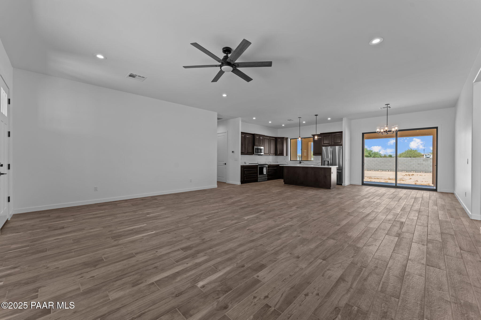 21032 West Skinner Road Wittmann, AZ 85361 - Photo 14 of 34 a view of empty room with wooden floor and window