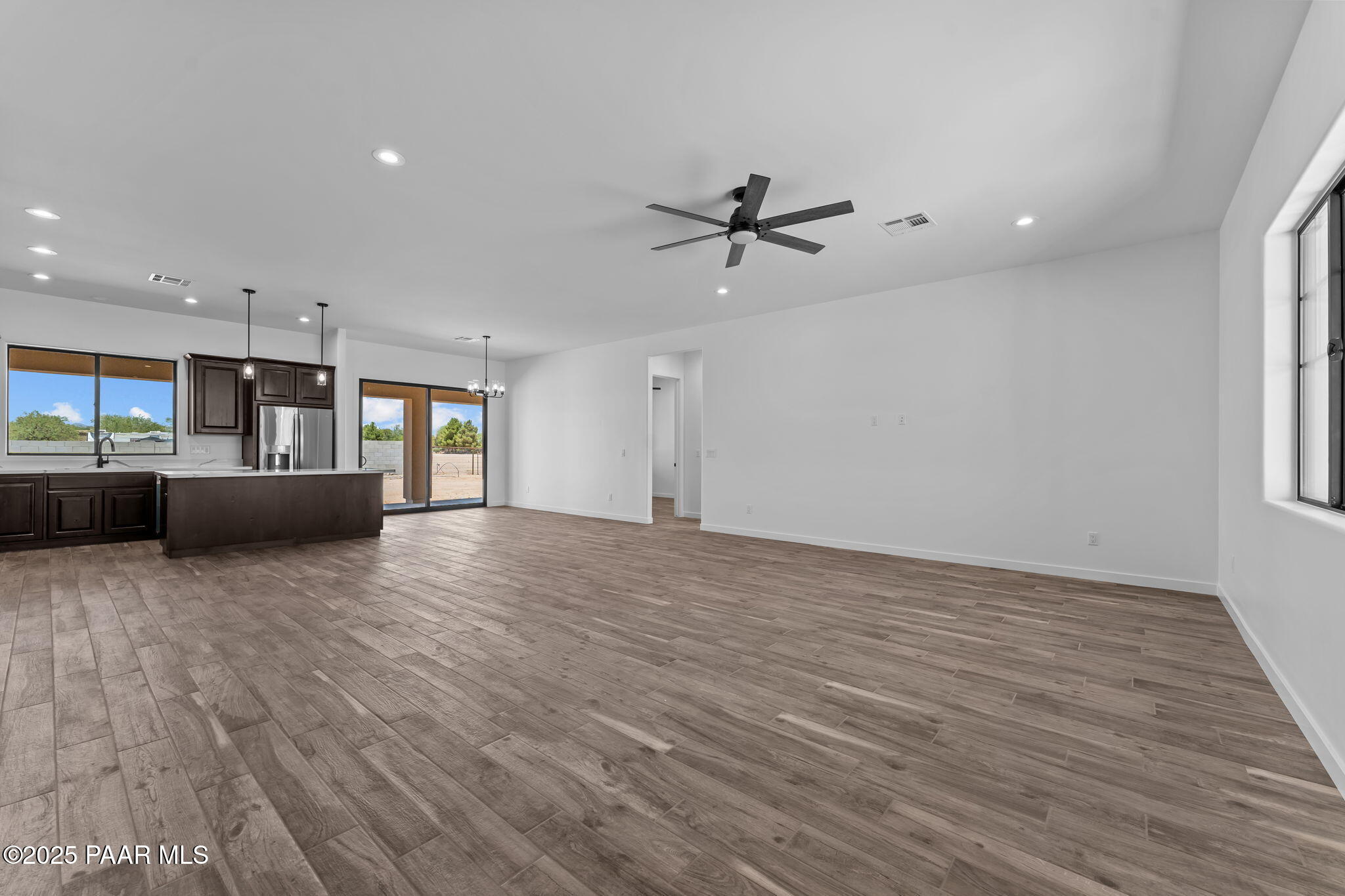 21032 West Skinner Road Wittmann, AZ 85361 - Photo 15 of 34 a view of an empty room with a window and kitchen view