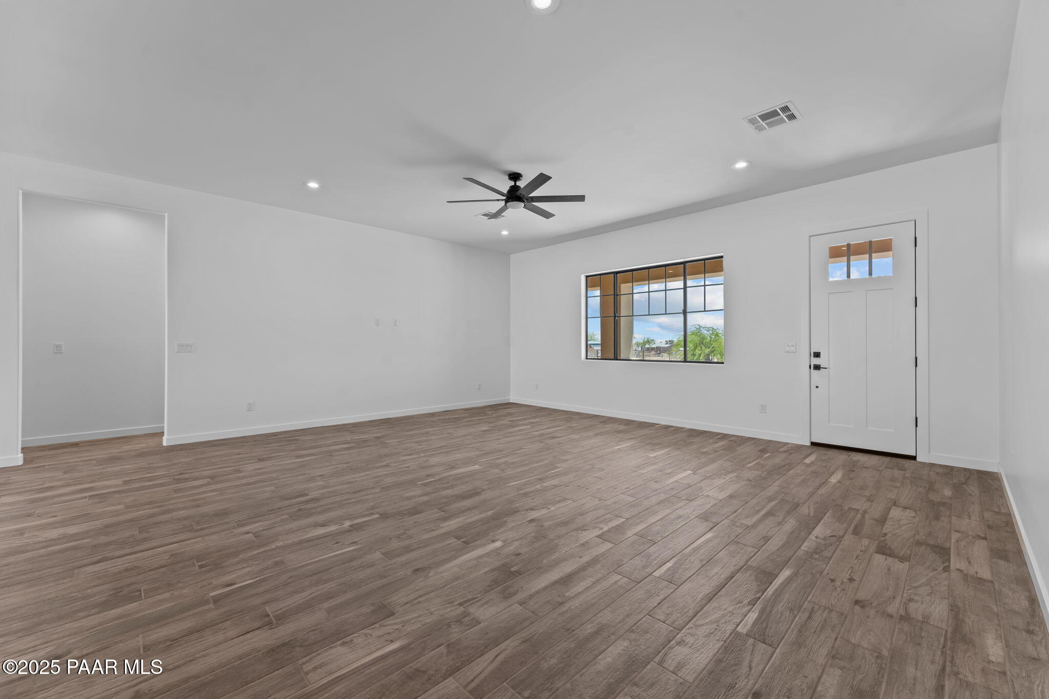 21032 West Skinner Road Wittmann, AZ 85361 - Photo 16 of 34 wooden floor in an empty room with a window