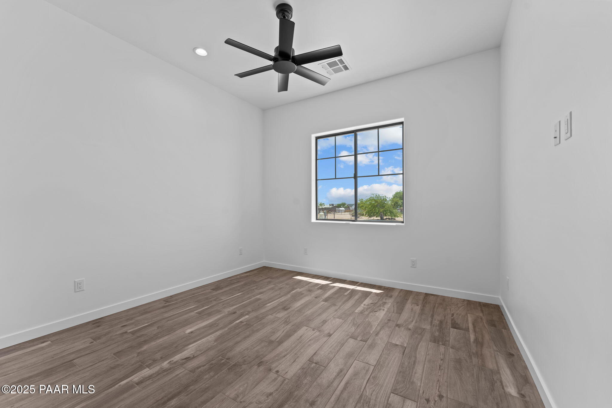 21032 West Skinner Road Wittmann, AZ 85361 - Photo 20 of 34 wooden floor in an empty room with a window