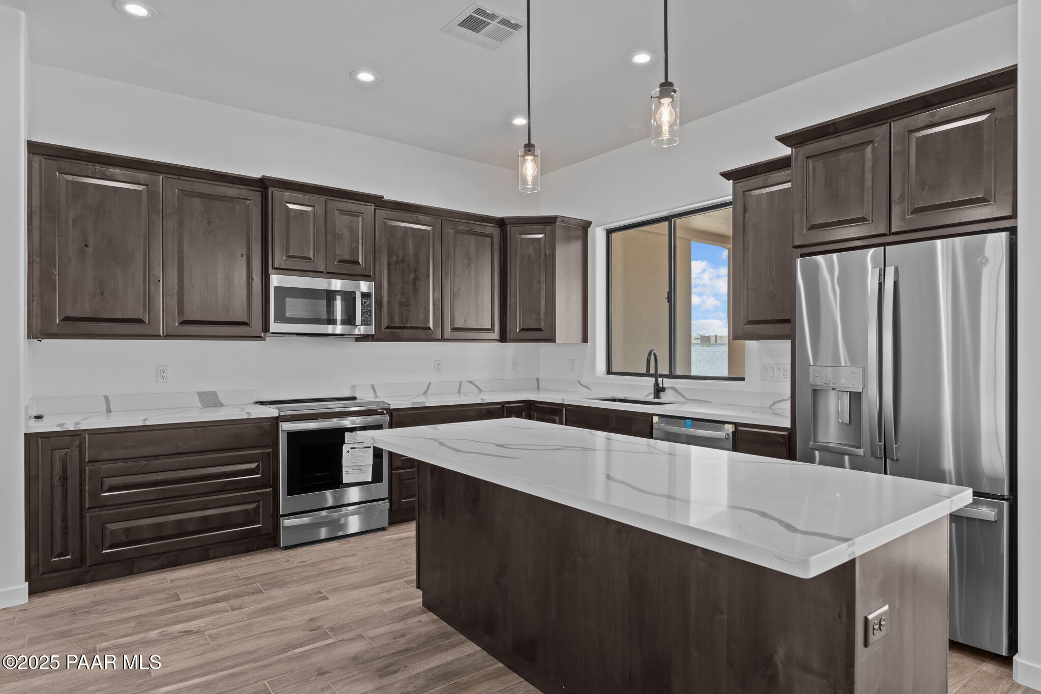 21032 West Skinner Road Wittmann, AZ 85361 - Photo 2 of 34 a kitchen with stainless steel appliances granite countertop a sink stove and refrigerator