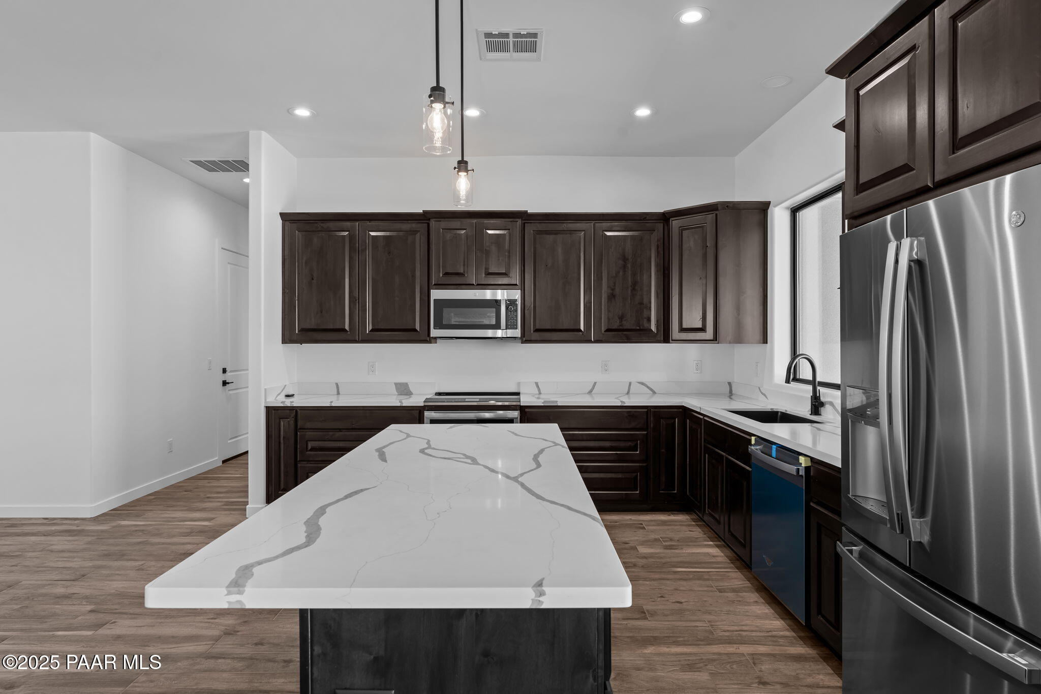 21032 West Skinner Road Wittmann, AZ 85361 - Photo 6 of 34 a kitchen with a sink a stove and refrigerator