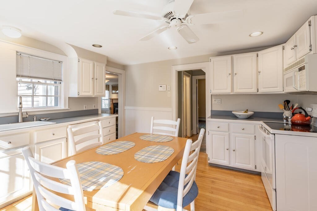 64 Wachusett Road Needham, MA 02492 - Photo 11 of 25 a kitchen with stainless steel appliances granite countertop a refrigerator a sink dishwasher a stove and white cabinets with wooden floor