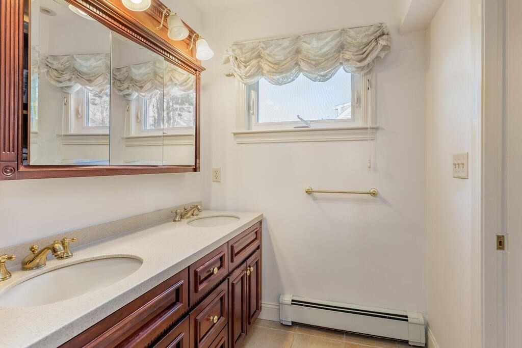 64 Wachusett Road Needham, MA 02492 - Photo 17 of 25 a bathroom with a sink and a mirror