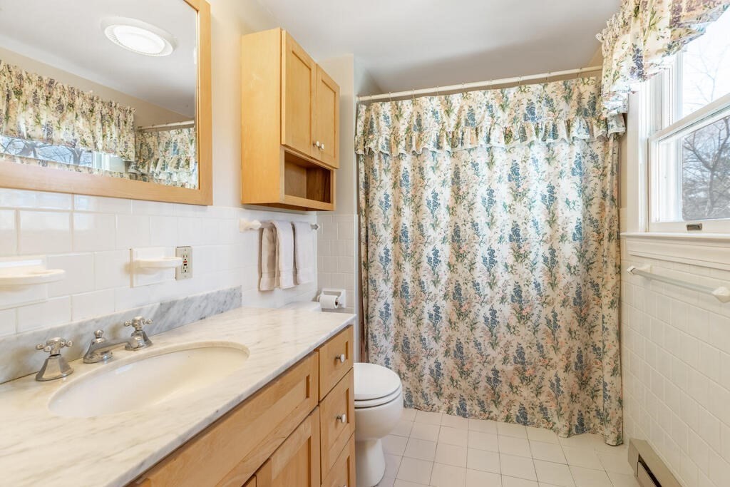 64 Wachusett Road Needham, MA 02492 - Photo 20 of 25 a bathroom with a granite countertop sink a toilet and a mirror