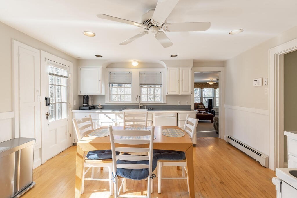 64 Wachusett Road Needham, MA 02492 - Photo 10 of 25 a kitchen with stainless steel appliances kitchen island granite countertop a refrigerator a stove and white cabinets with wooden floor