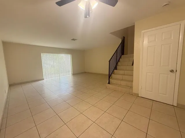 a view of an empty room and stairs