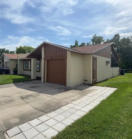 a view of backyard of house with green space