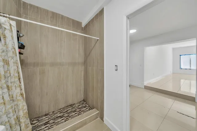 a bedroom with furniture and a flat screen tv