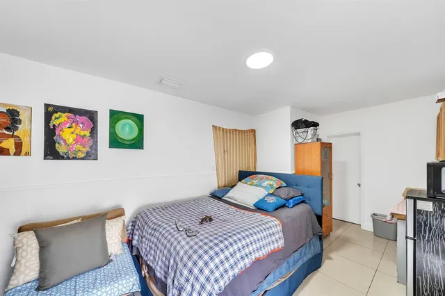 a bedroom with bed and a window