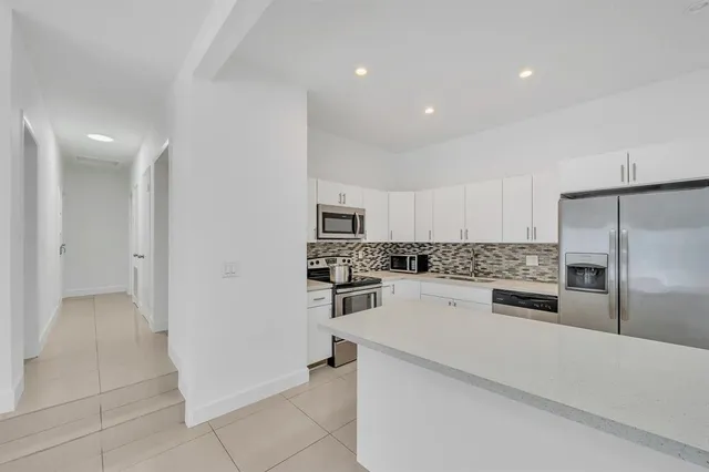 a kitchen with cabinets and stainless steel appliances