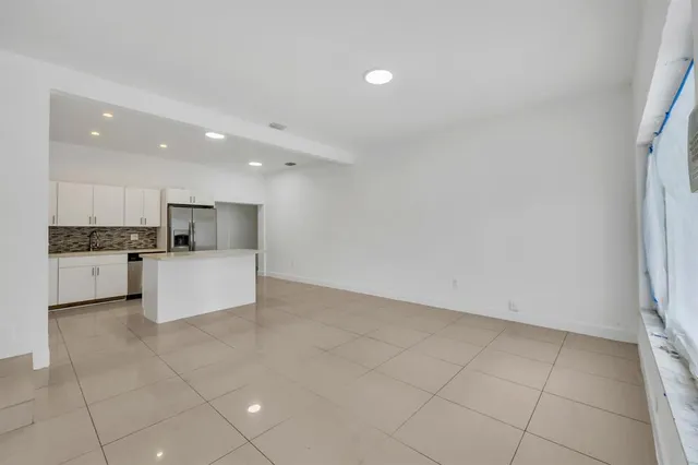 a view of kitchen with granite countertop a sink and a stove top oven