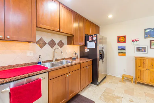a spacious kitchen with stainless steel appliances granite countertop a sink and cabinets