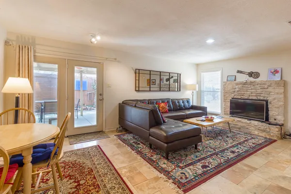 a room with furniture a rug and a window