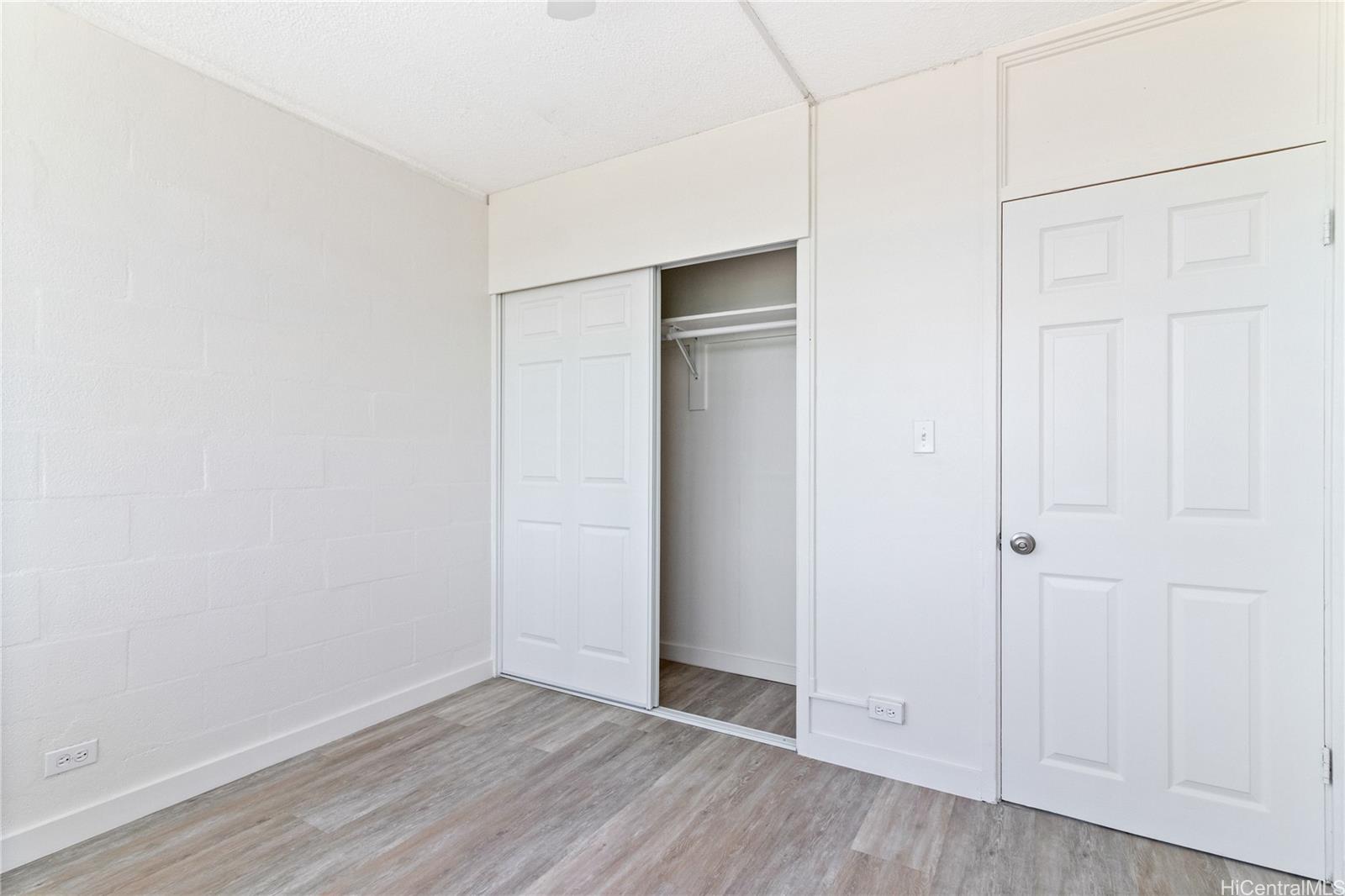 94-249 Waikele Road, Unit A307 Waipahu, HI 96797 - Photo 8 of 20 an empty room with wooden floor