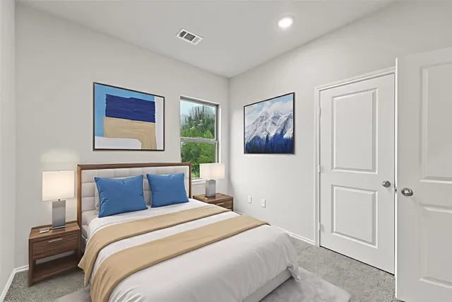 a bedroom with a large bed and a window