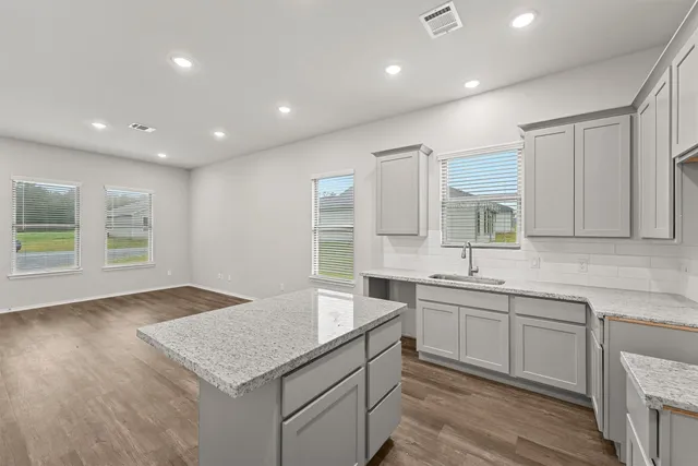 a kitchen with a sink stove and cabinets