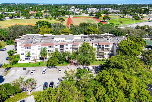 an aerial view of residential houses with outdoor space and river view