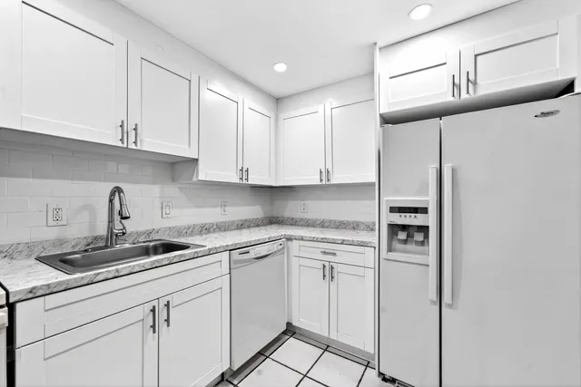 a kitchen with cabinets and appliances