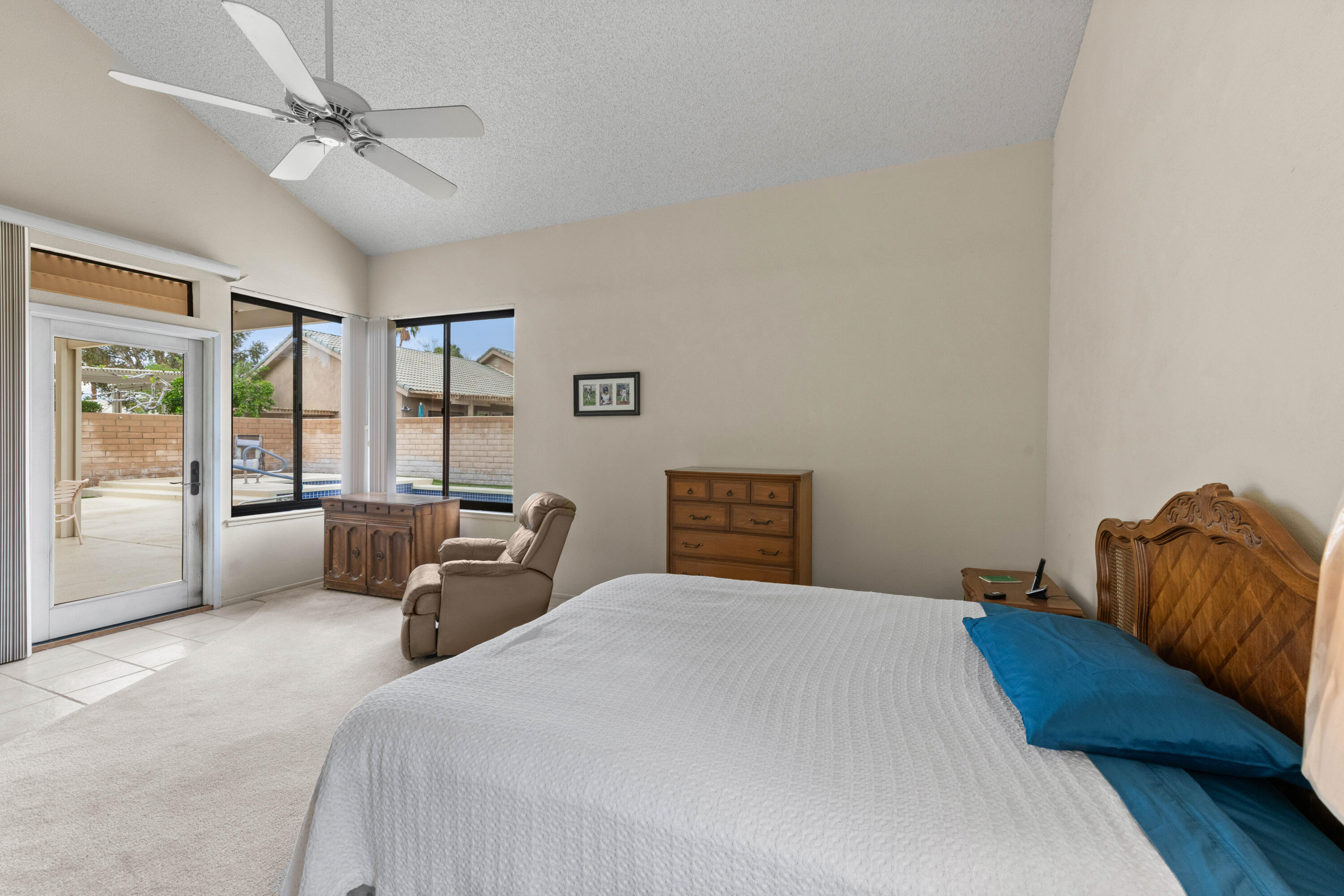 53 San Simeon Place Rancho Mirage, CA 92270 - Photo 15 of 30 a bedroom with a bed couches and window