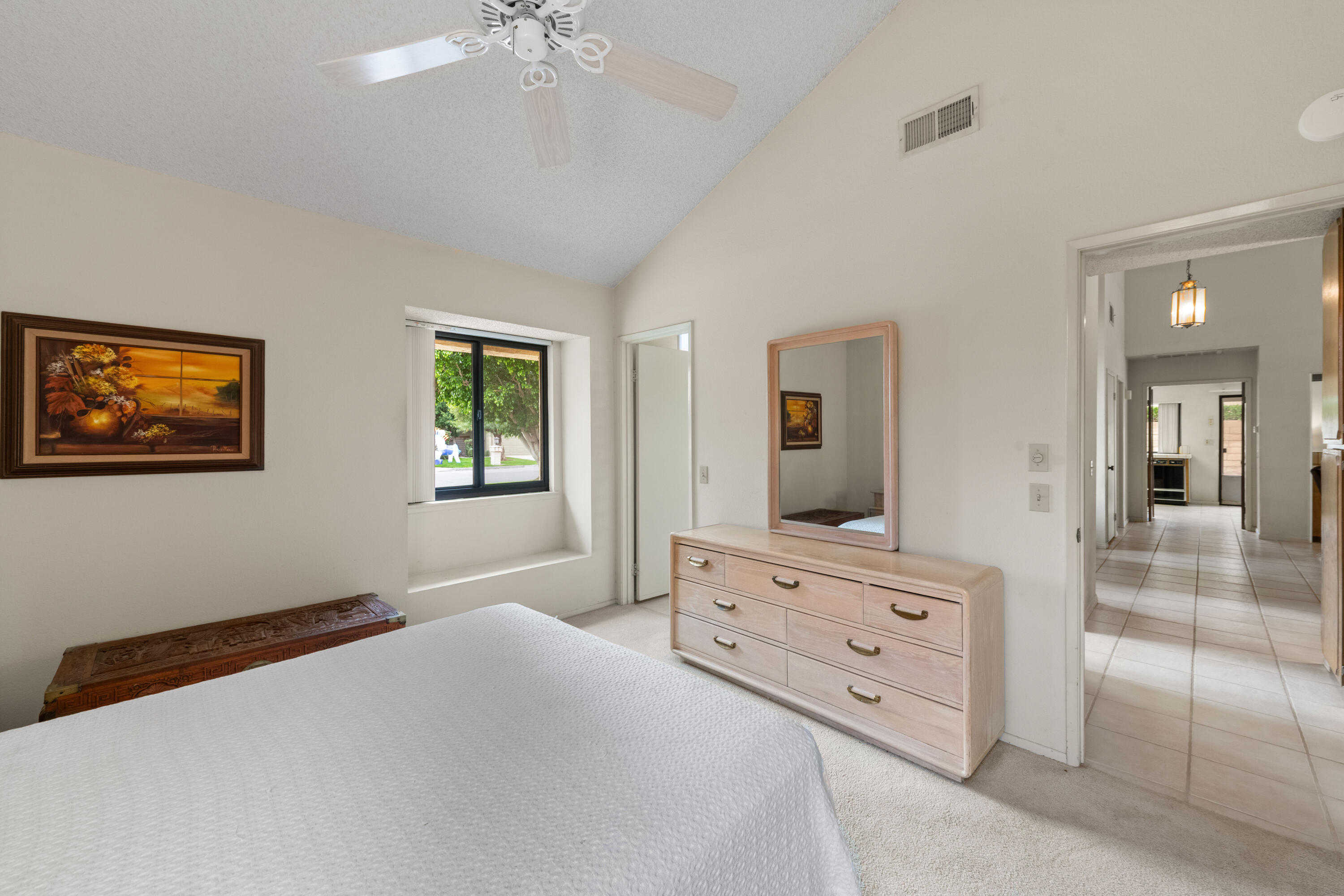 53 San Simeon Place Rancho Mirage, CA 92270 - Photo 20 of 30 a bedroom with a large bed and a dresser