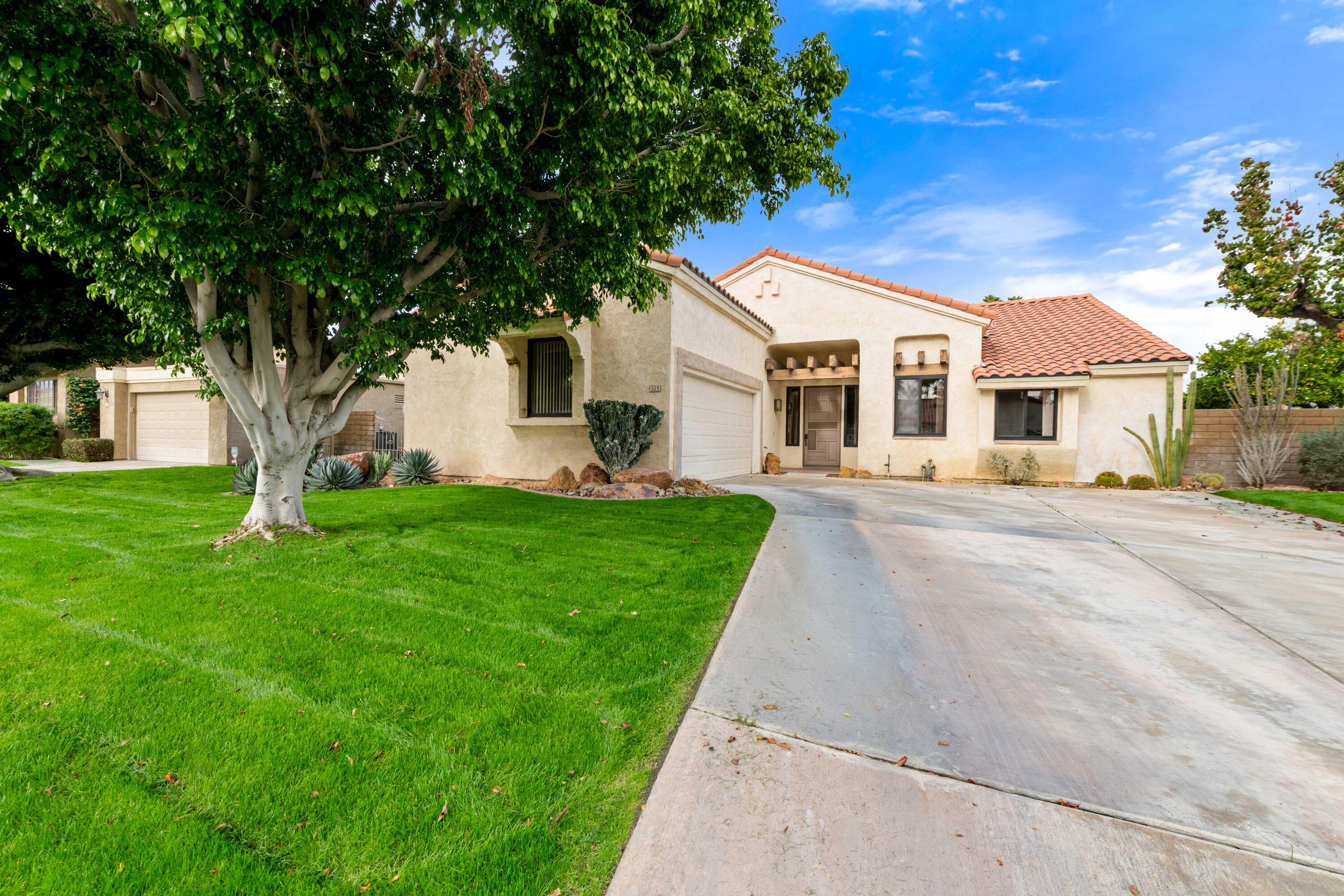 53 San Simeon Place Rancho Mirage, CA 92270 - Photo 2 of 30 a front view of a house with a yard