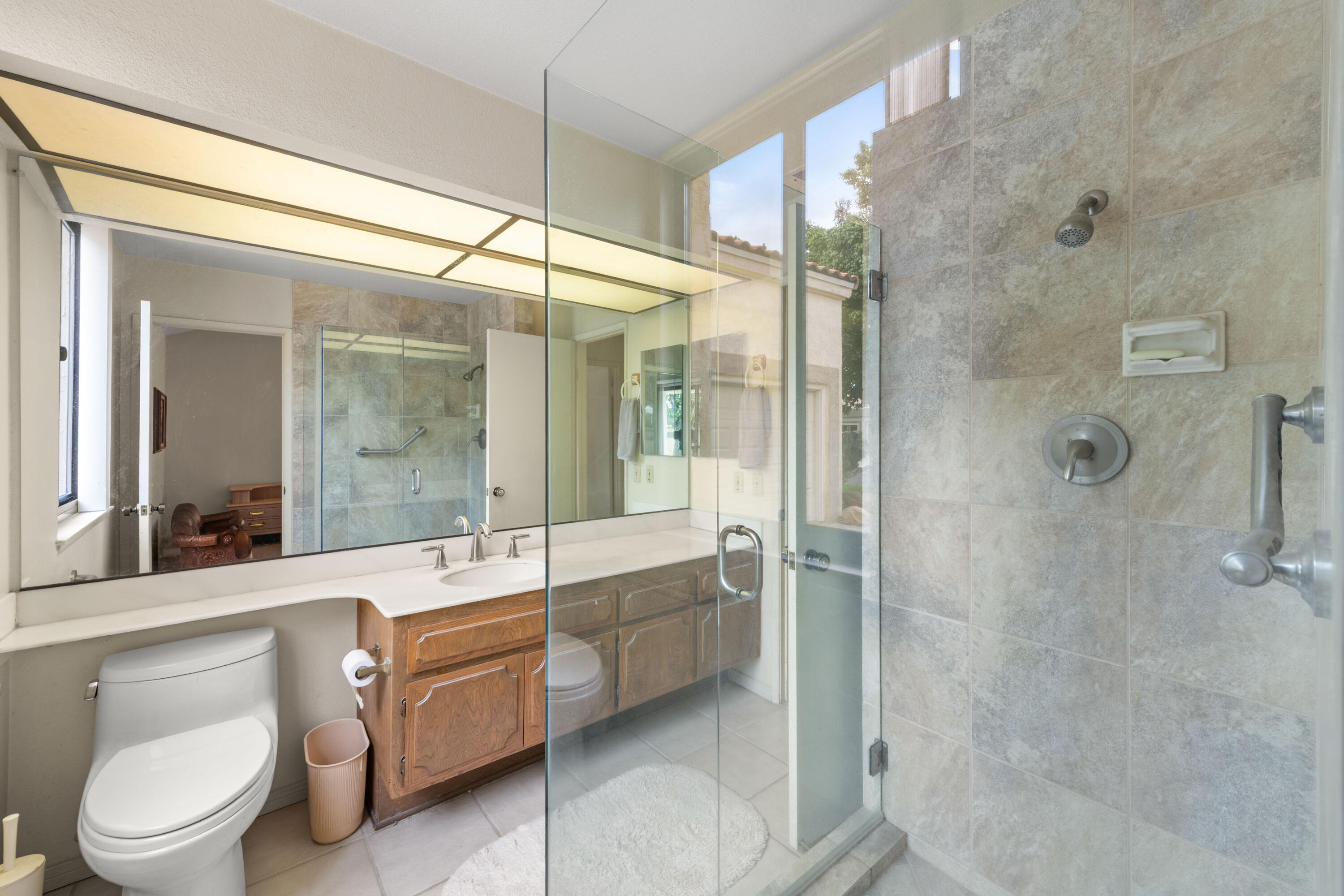 53 San Simeon Place Rancho Mirage, CA 92270 - Photo 22 of 30 a bathroom with a double vanity sink toilet and shower