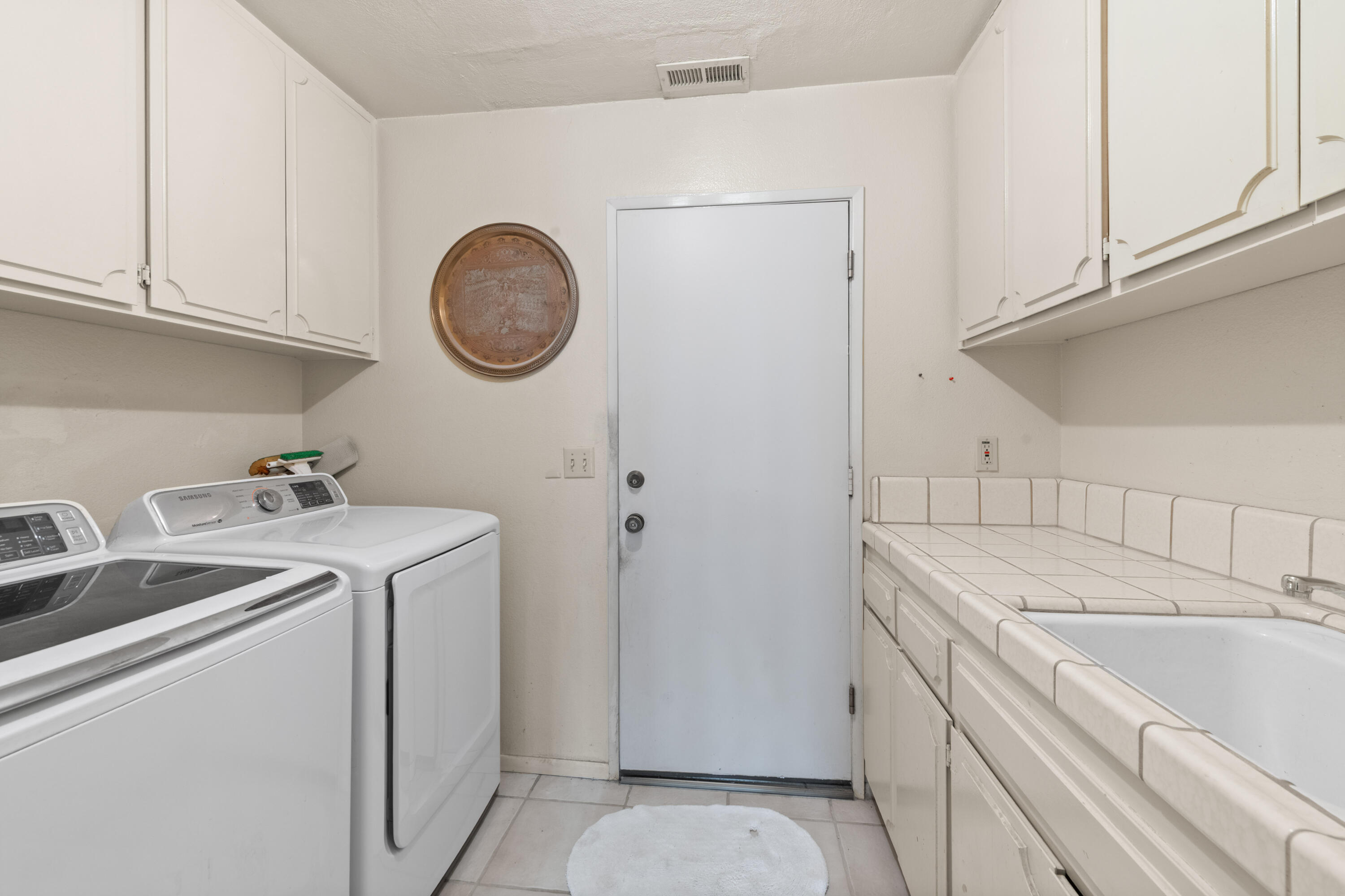 53 San Simeon Place Rancho Mirage, CA 92270 - Photo 23 of 30 a utility room with sink dryer and washer