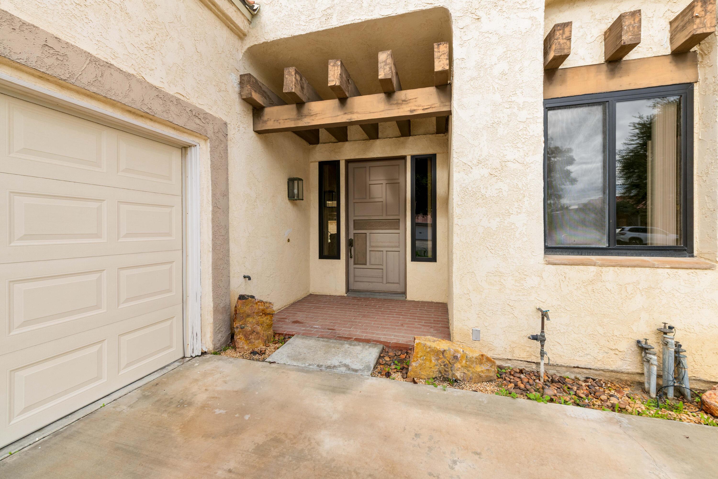 53 San Simeon Place Rancho Mirage, CA 92270 - Photo 3 of 30 a front view of a house with a yard