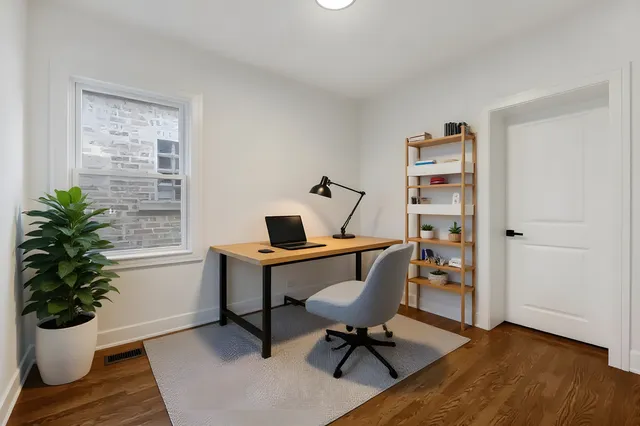 a view of a workspace with furniture and a potted plant