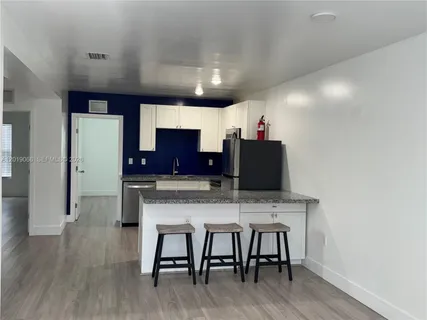 a large kitchen with a table and chairs
