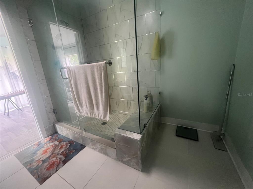 5855 Jack Brack Road St. Cloud, FL 34771 - Photo 14 of 86 a bathroom with a shower and a toilet