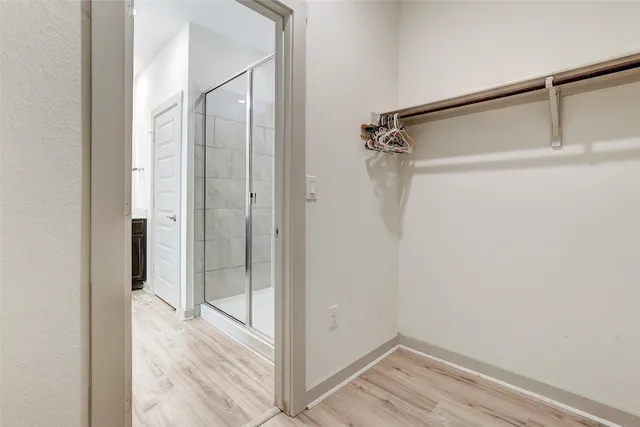 a bathroom with a granite countertop sink mirror and shower