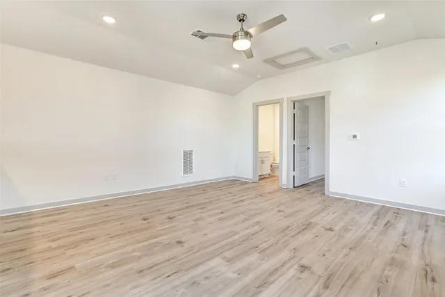 an empty room with wooden floor & closet