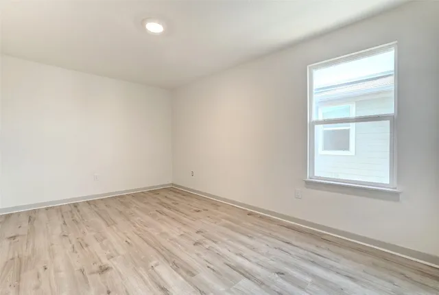 a bathroom with a granite countertop toilet a sink and a shower