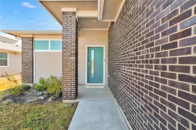 a view of a brick house with a street