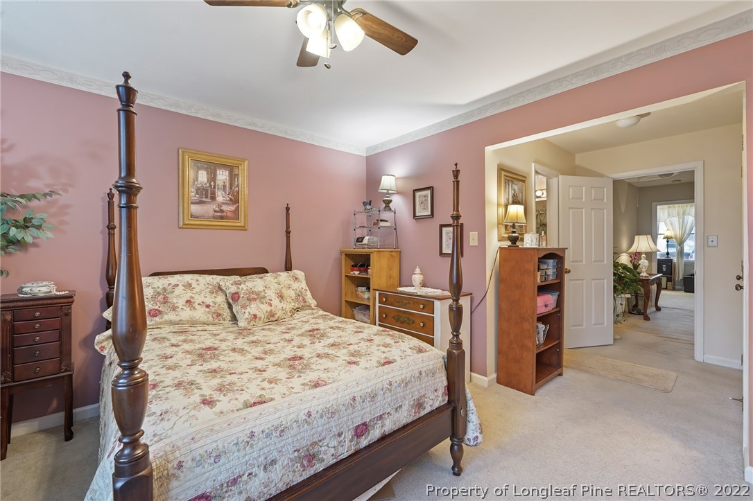 4372 Bona Court Raleigh, NC 27604 - Photo 21 of 41 a bedroom with a bed and a chandelier