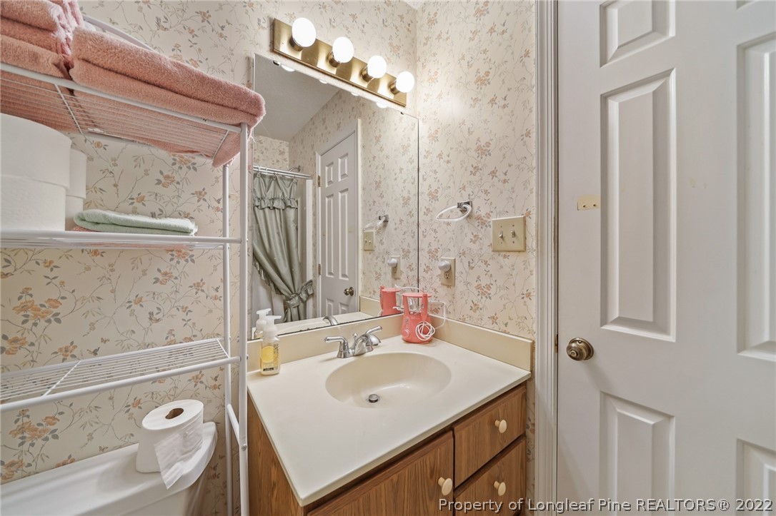 4372 Bona Court Raleigh, NC 27604 - Photo 23 of 41 a bathroom with a sink vanity granite tub and shower