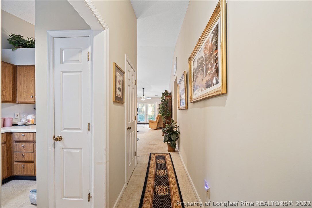 4372 Bona Court Raleigh, NC 27604 - Photo 3 of 41 a view of a hallway with a white walls and wooden floor