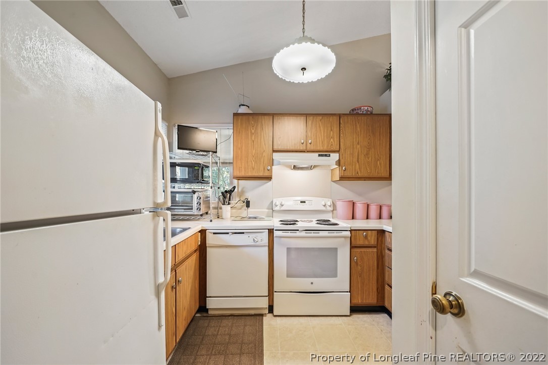 4372 Bona Court Raleigh, NC 27604 - Photo 4 of 41 a kitchen with stainless steel appliances granite countertop a sink a stove and a refrigerator