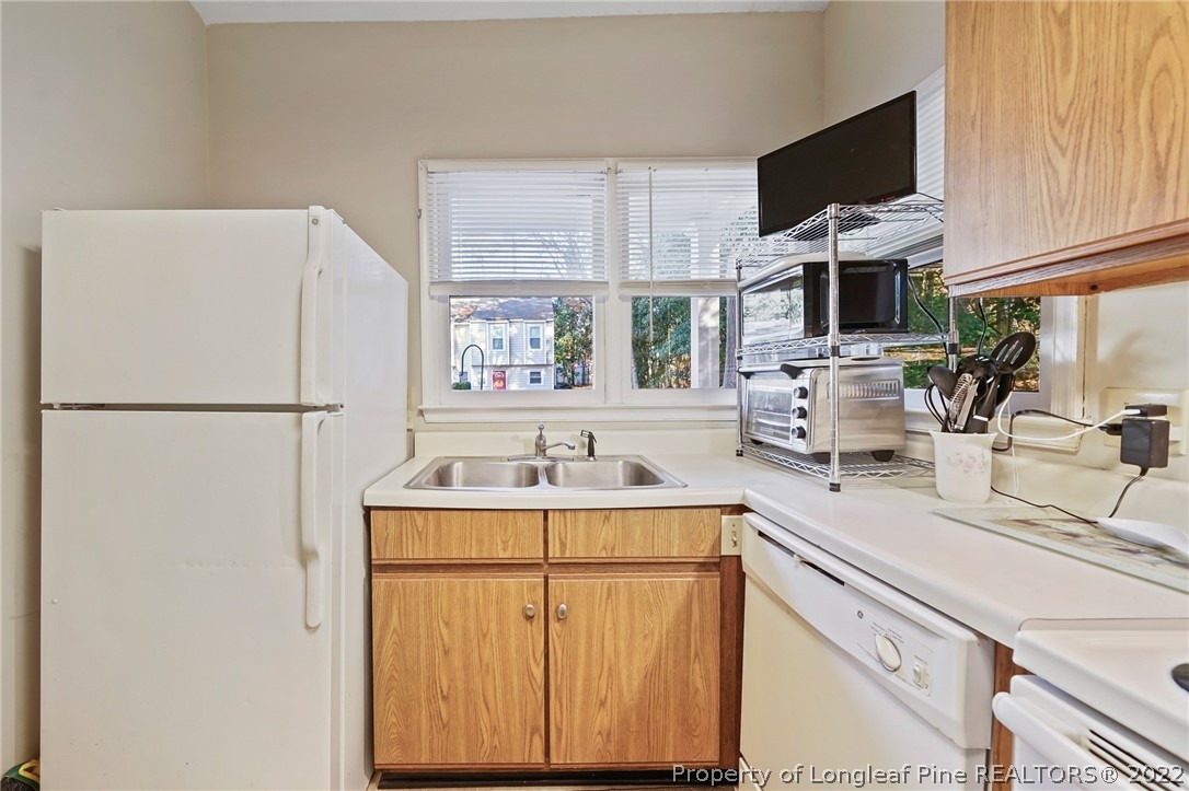4372 Bona Court Raleigh, NC 27604 - Photo 5 of 41 a kitchen with a sink and a refrigerator