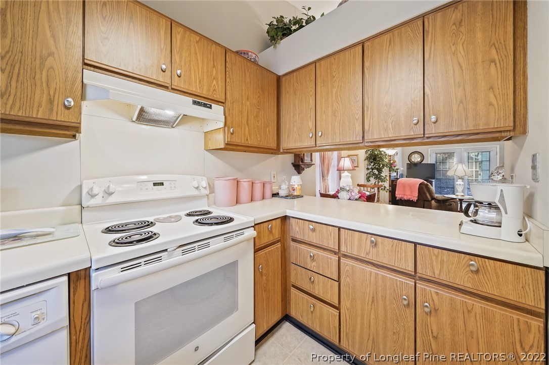 4372 Bona Court Raleigh, NC 27604 - Photo 6 of 41 a kitchen with white cabinets sink and white appliances