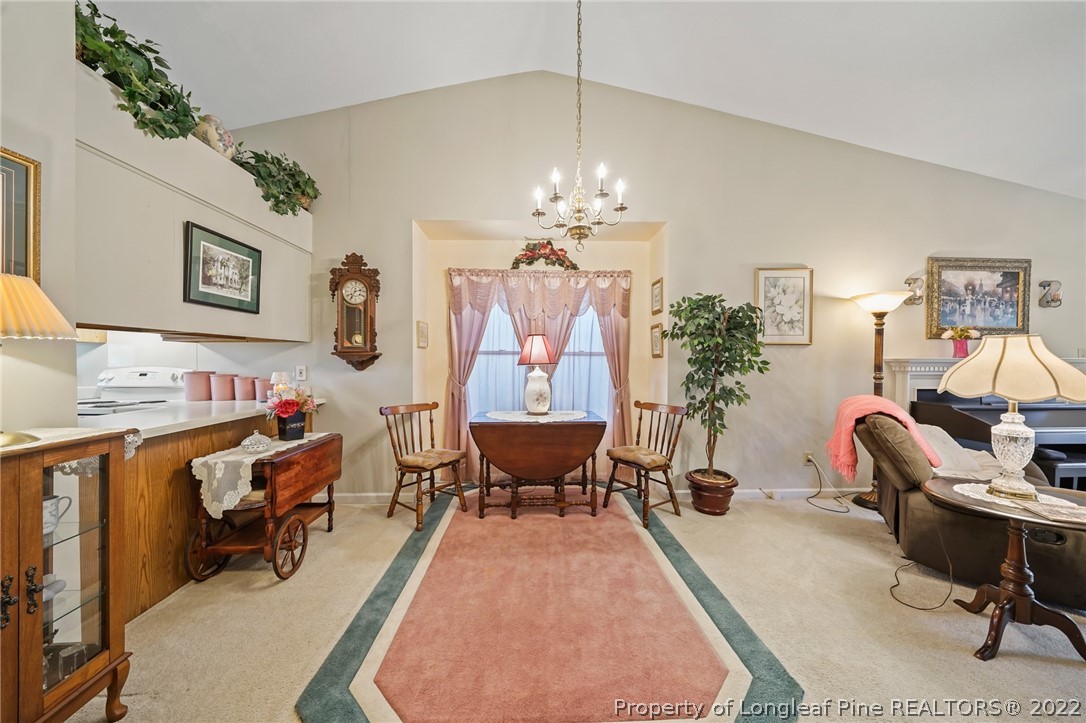 4372 Bona Court Raleigh, NC 27604 - Photo 8 of 41 a living room with furniture and a chandelier