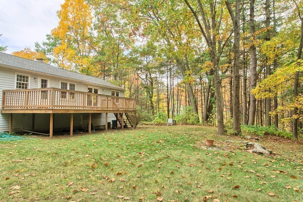 597 Old Dunstable Road Groton, MA 01450 - Photo 19 of 21 a backyard of a house with large trees and plants