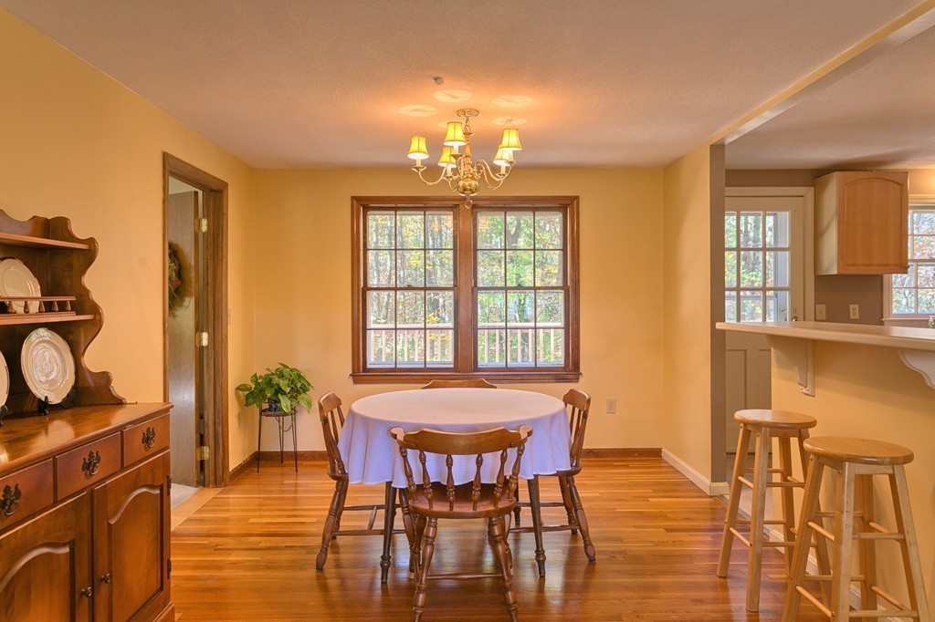 597 Old Dunstable Road Groton, MA 01450 - Photo 8 of 21 a view of a dining room with furniture and chandelier