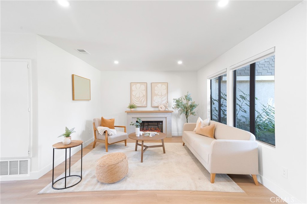 832 Cornwall Drive Anaheim, CA 92804 - Photo 9 of 30 a living room with furniture a fireplace and a potted plant