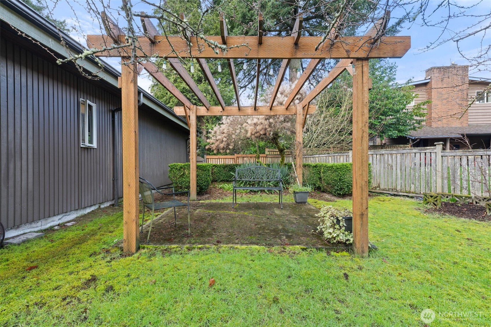 1007 Panorama Court Fircrest, WA 98466 - Photo 31 of 39 a view of a yard with table and chairs and wooden fence