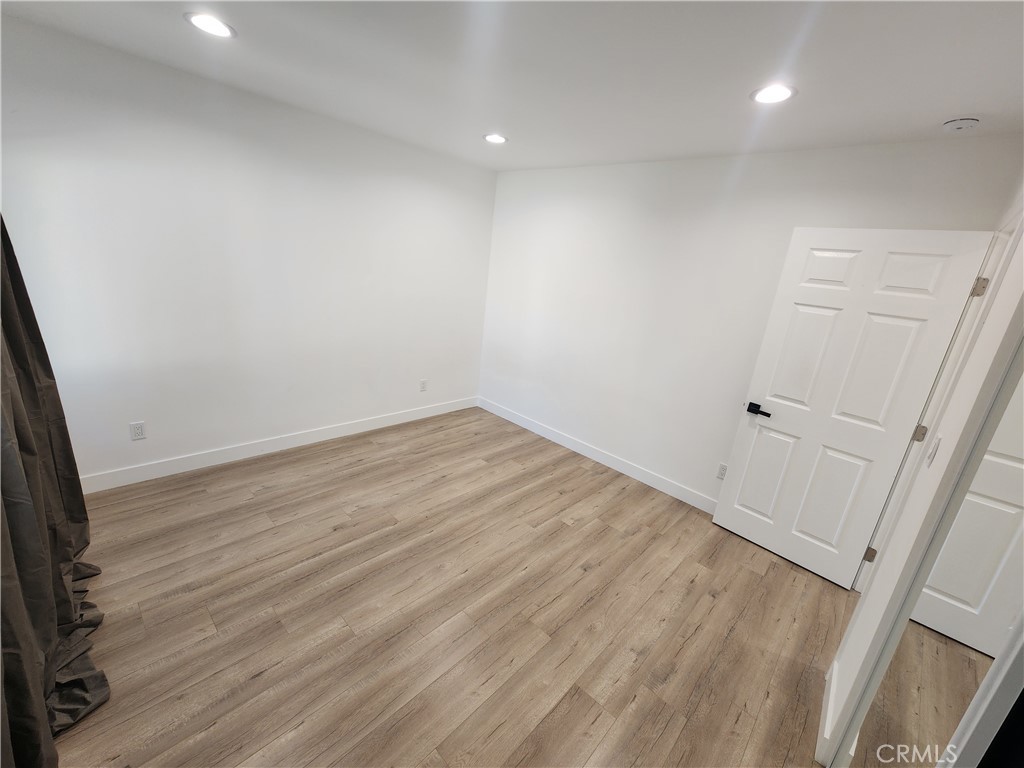 7665 Machrea Street Tujunga, CA 91042 - Photo 12 of 43 a view of room with wooden floor and fan