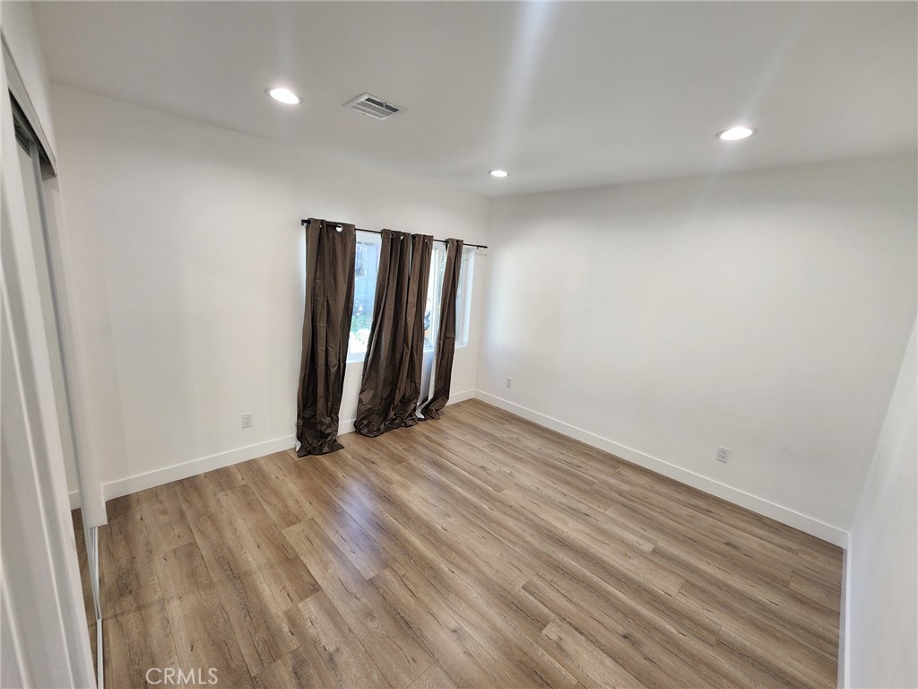 7665 Machrea Street Tujunga, CA 91042 - Photo 13 of 43 a view of an empty room with wooden floor