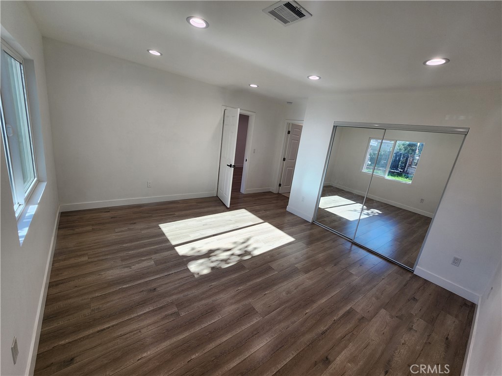 7665 Machrea Street Tujunga, CA 91042 - Photo 14 of 43 an empty room with wooden floor and windows